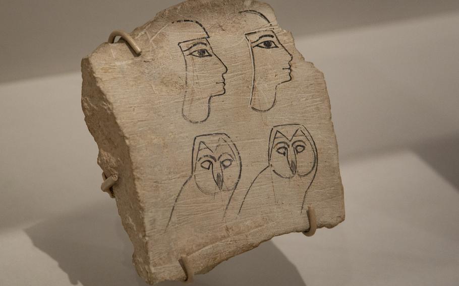 a person and an animal drawings on a stone